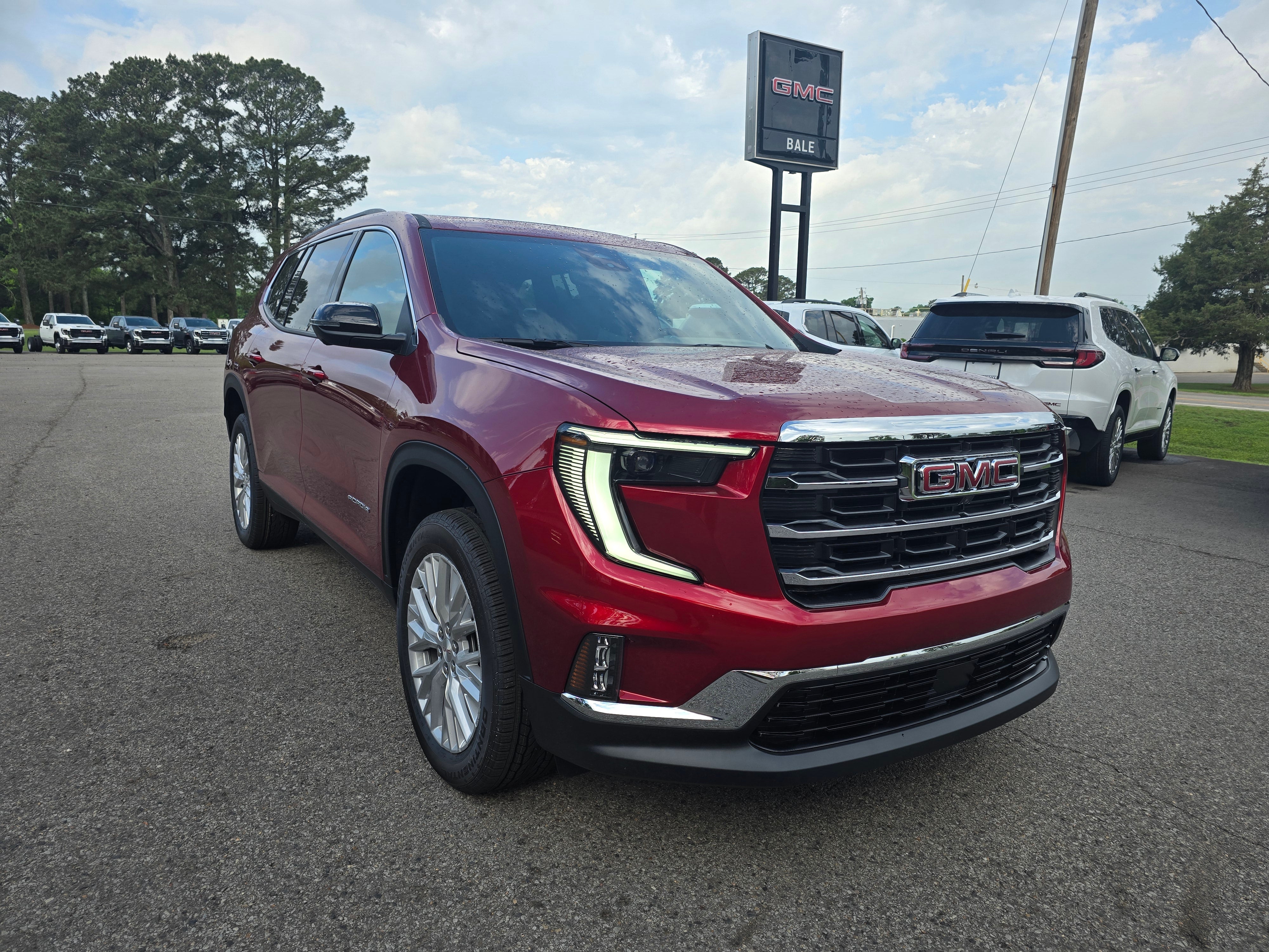 2026 GMC Acadia Elevation in Volcanic Red Tintcoat — front three-quarter view