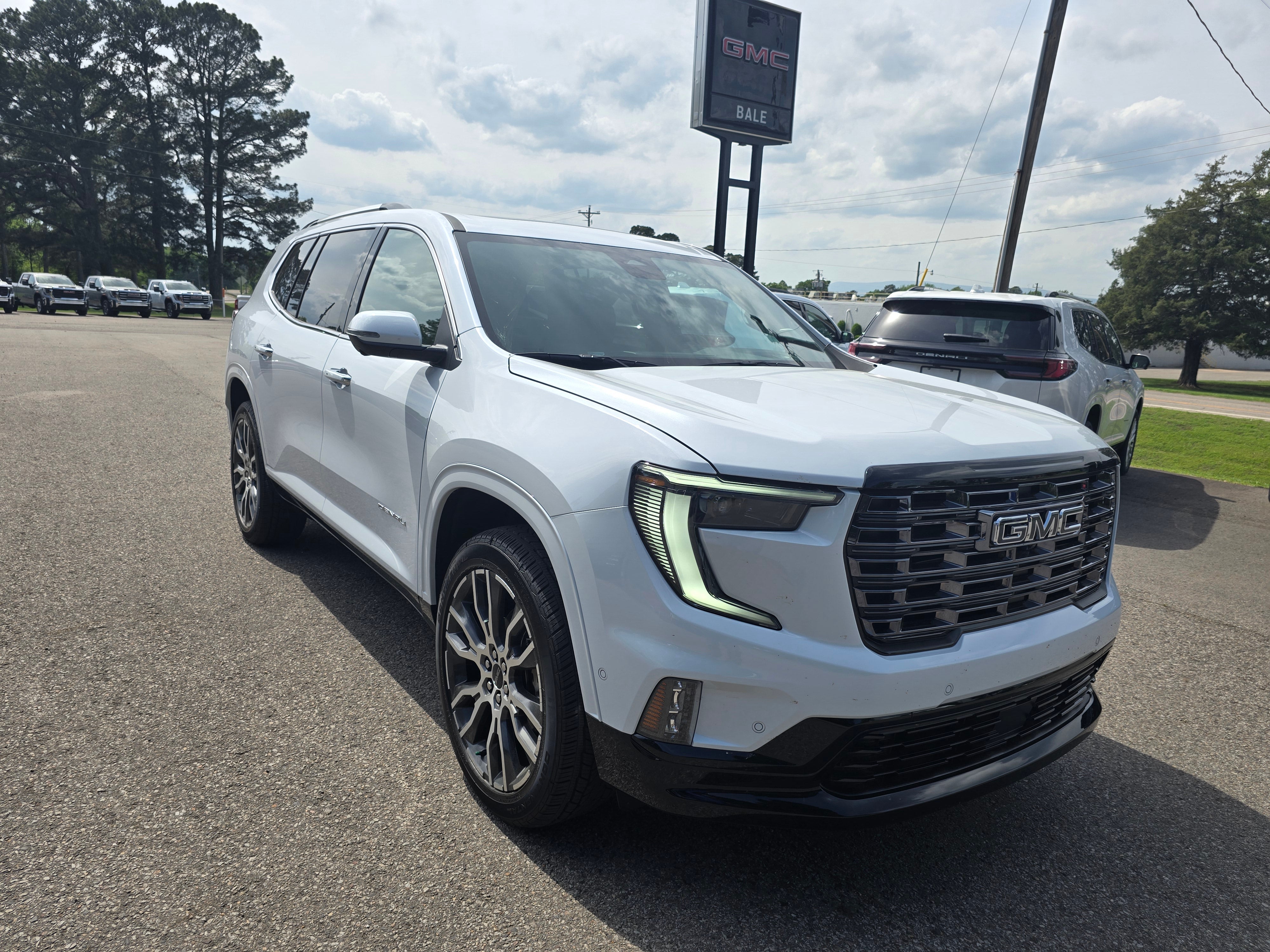 2026 GMC Acadia Denali Ultimate in Glacier White Tricoat — front three-quarter view